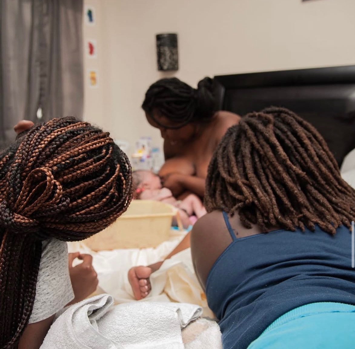 Midwife checking a newborn during a water birth